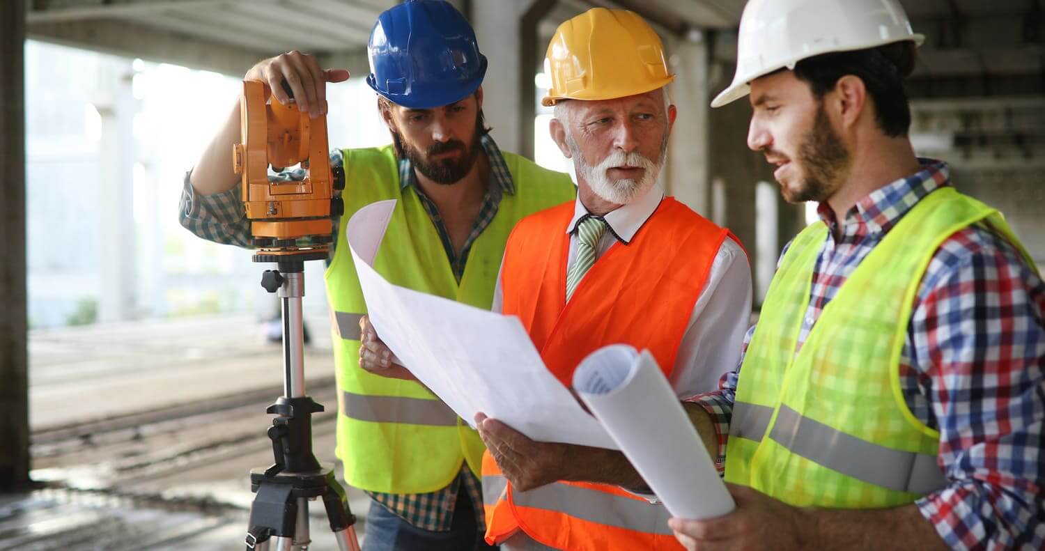 construction workers reviewing blueprints